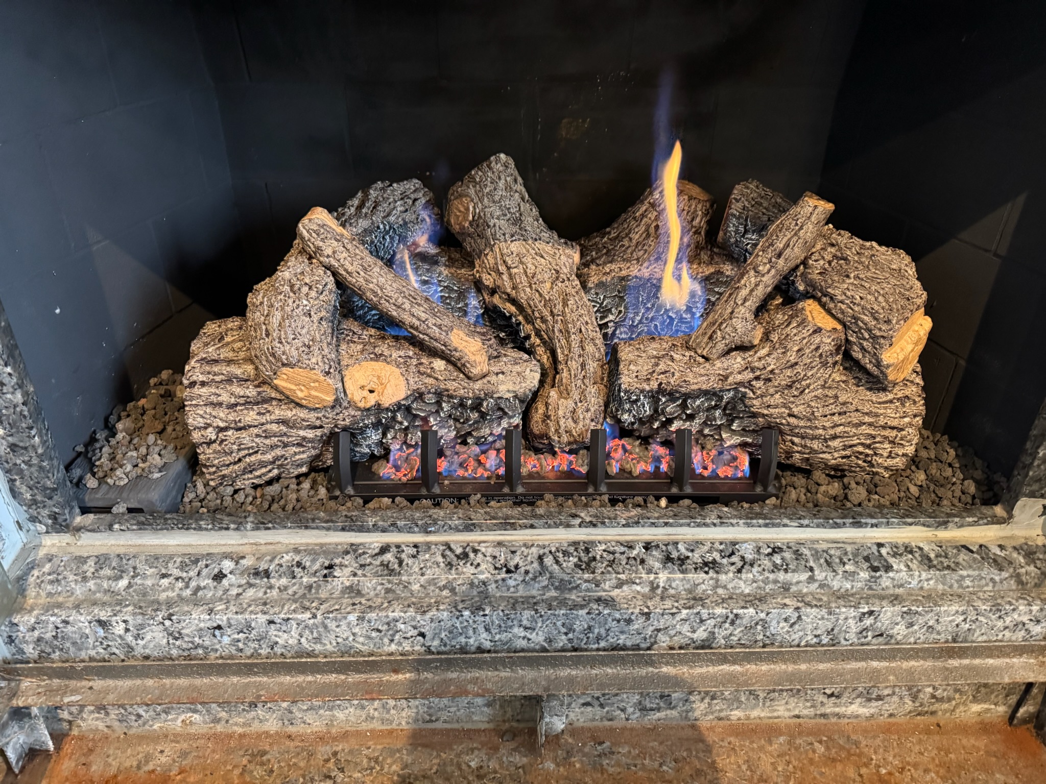 Gas fireplace being serviced by a technician